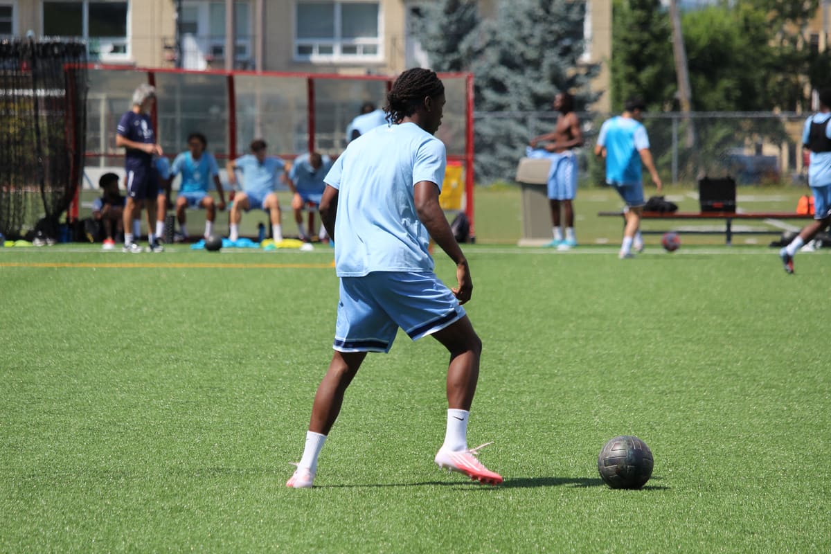 Matthieu Jean-Baptiste en maillot bleu clair, de dos, à l'entraînement